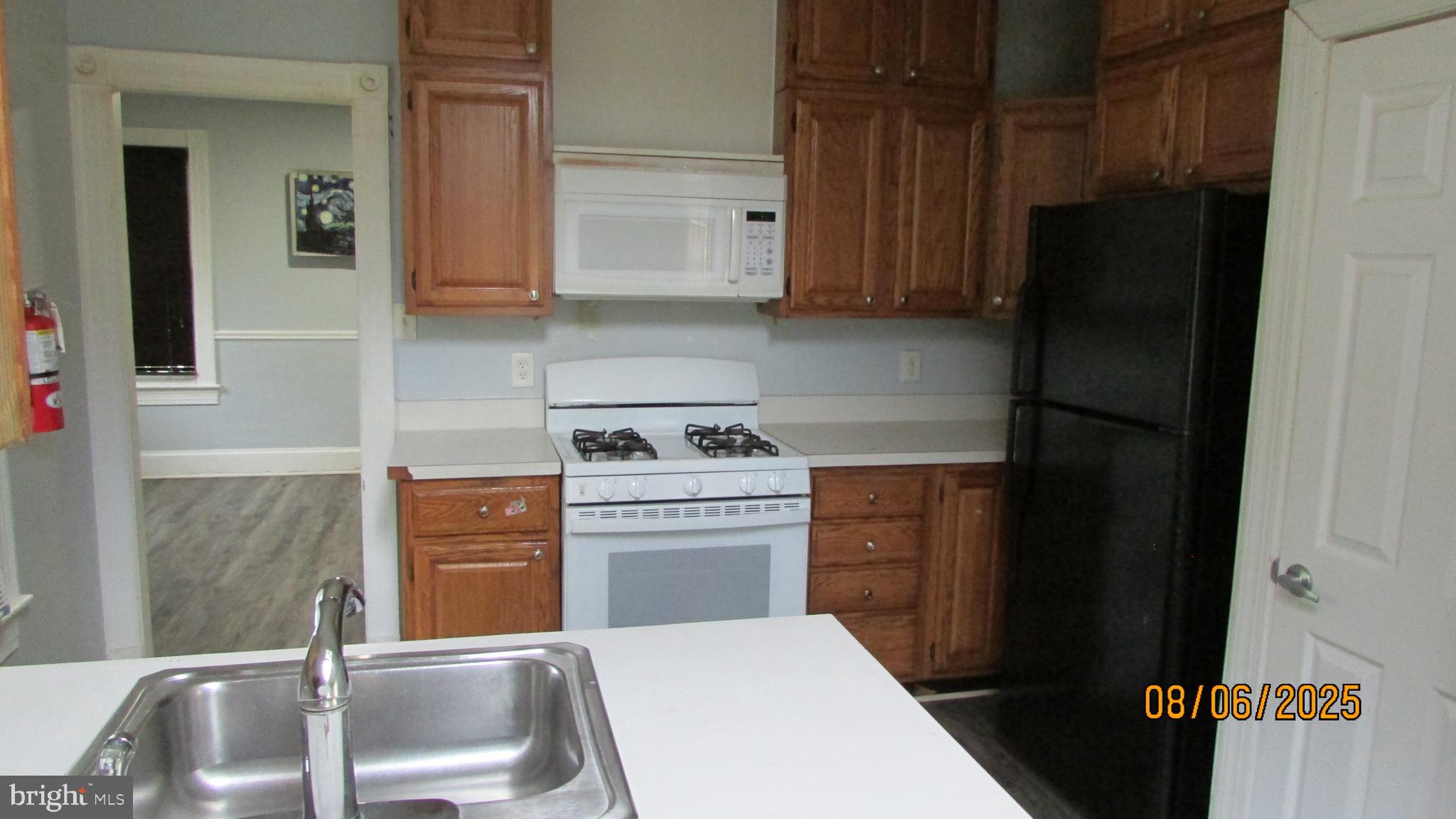 4724 Branchville Road College Park, MD 20740 - Photo 15 of 41 a kitchen with stainless steel appliances a refrigerator and cabinets