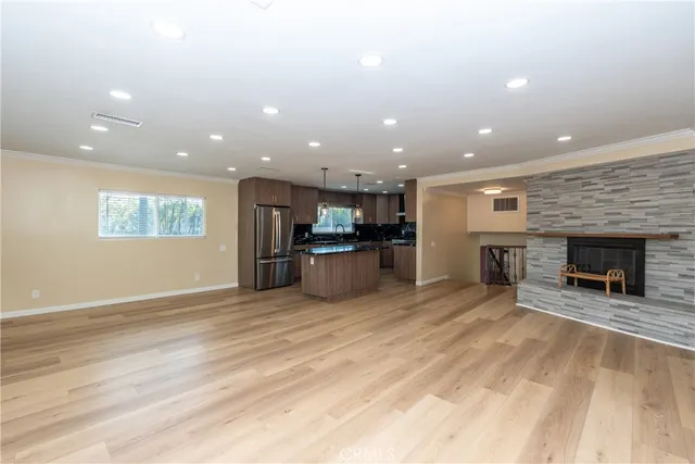 a view of a kitchen with a sink and a fireplace