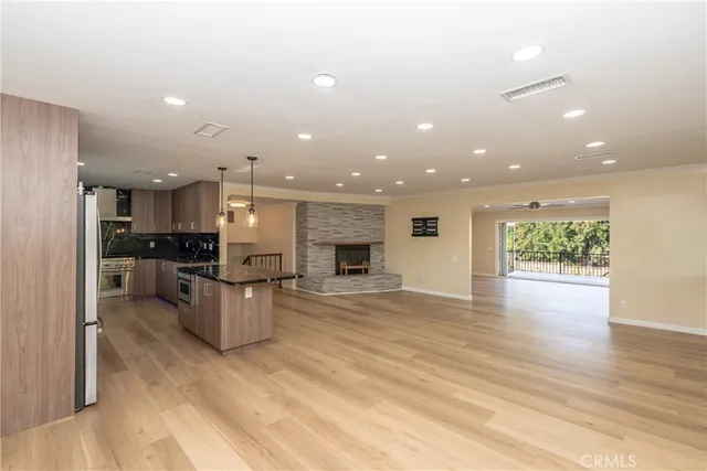 a view of kitchen with kitchen island microwave and stove refrigerator