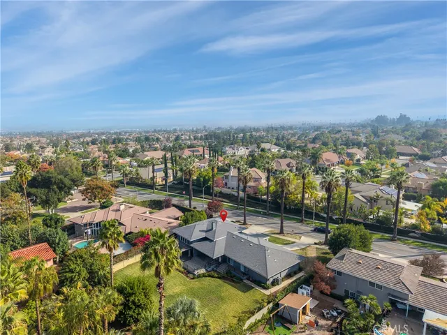 an aerial view of a house with a yard