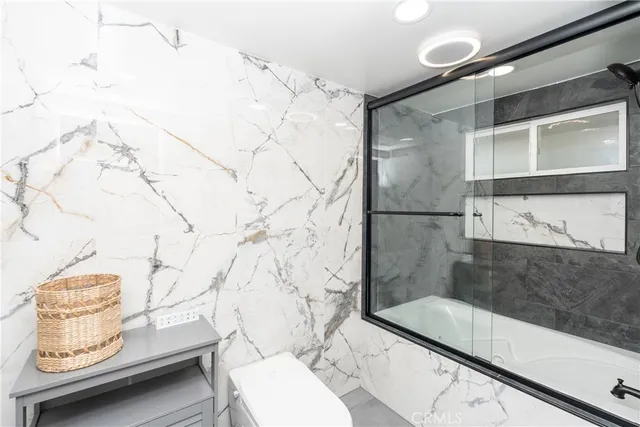 a bathroom with a tub sink and mirror
