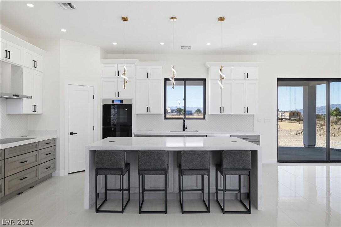 5910 East Kellogg Road Pahrump, NV 89061 - Photo 16 of 58 Culinary excellence awaits in this well-appointed kitchen, featuring a spacious island for entertaining.