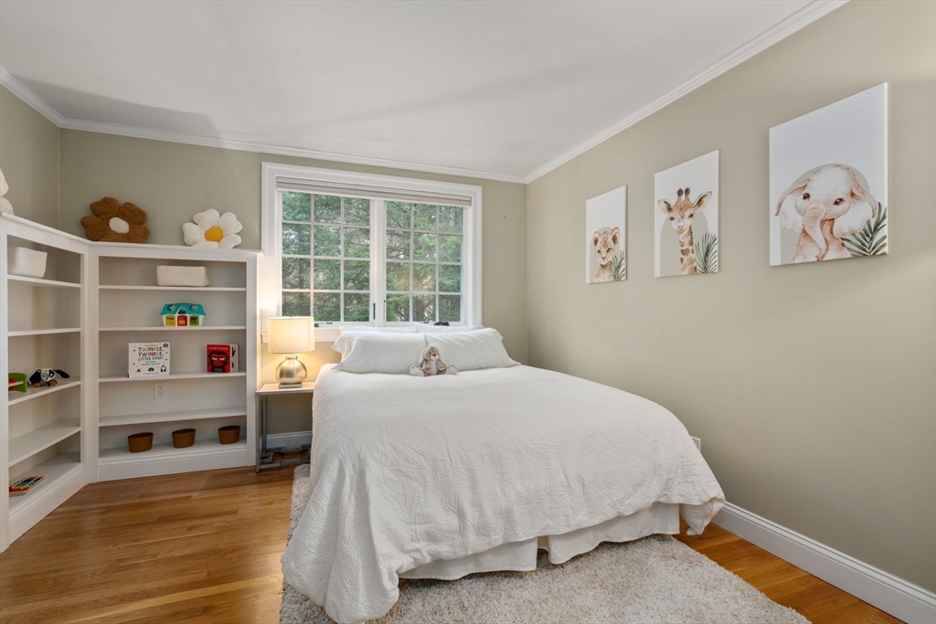 156 Cherry Brook Road Weston, MA 02493 - Photo 18 of 38 a bedroom with a bed and book shelf