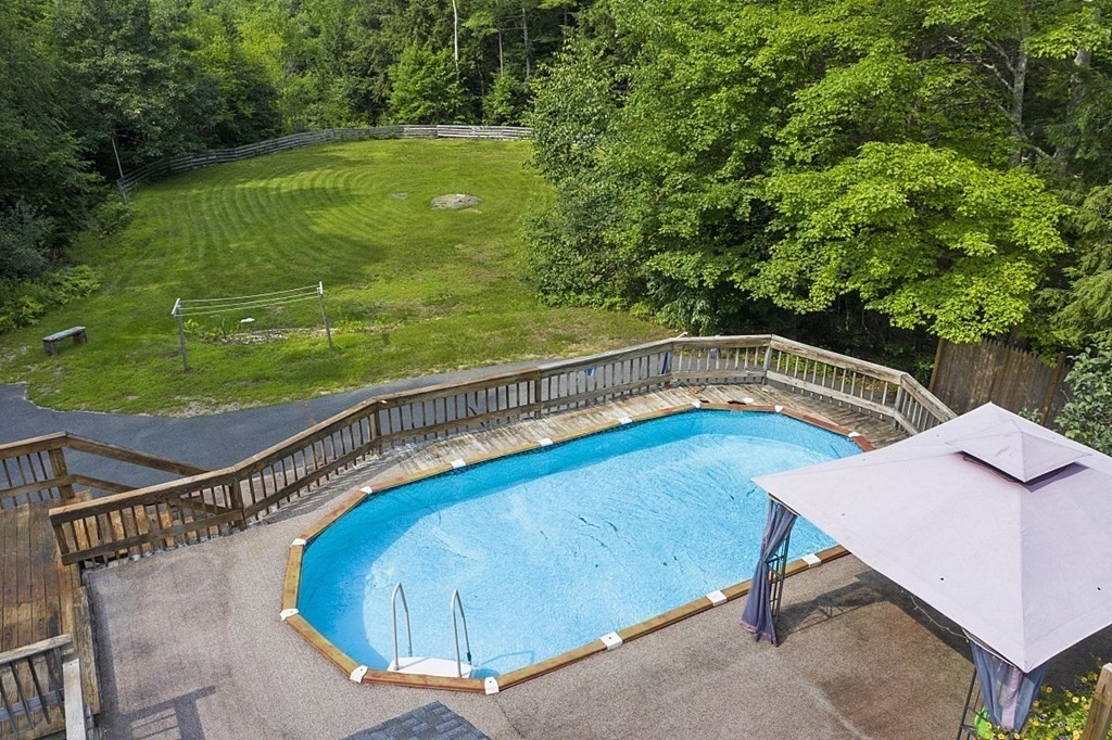 590 Doe Valley Road Athol, MA 01331 - Photo 9 of 37 a view of a swimming pool with a patio and a yard
