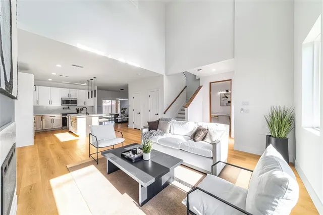 a living room with furniture kitchen view and a potted plant