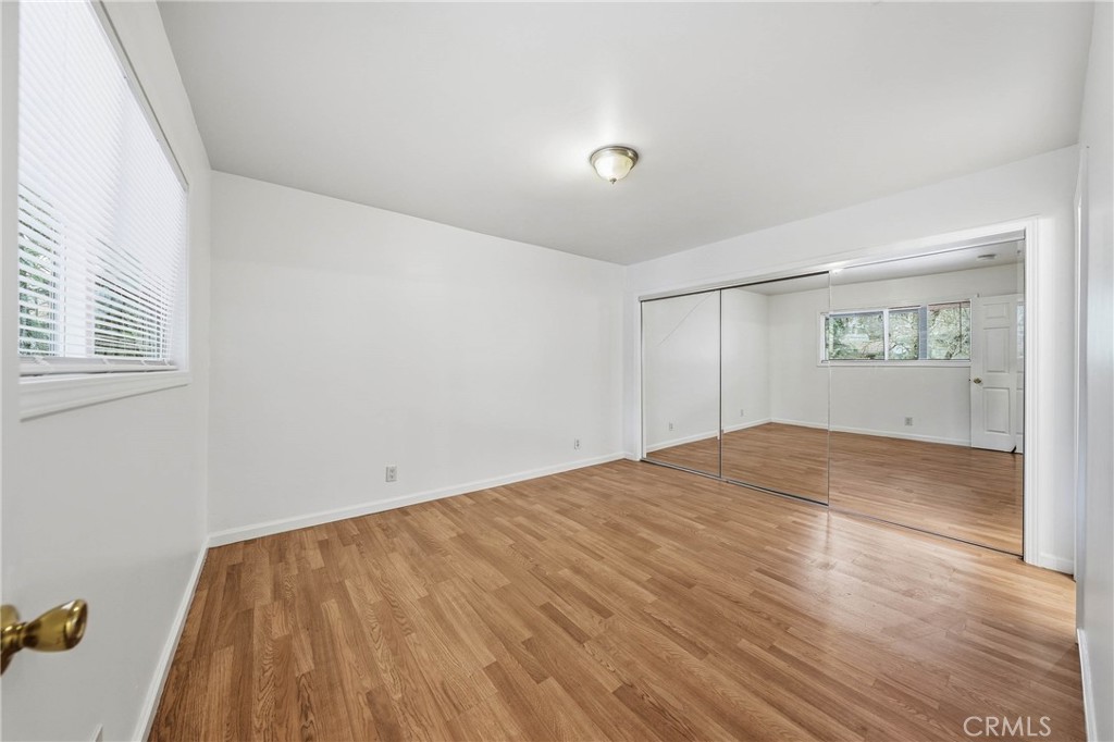 6150 Ridgeview Drive Clearlake, CA 95422 - Photo 20 of 38 a view of empty room with wooden floor and fan