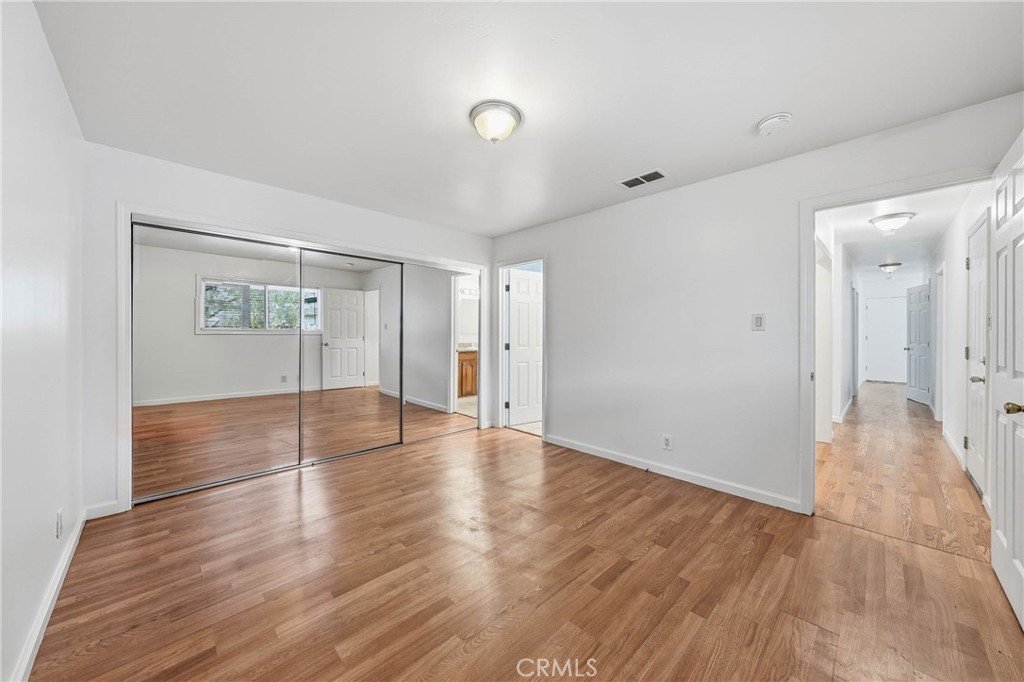 6150 Ridgeview Drive Clearlake, CA 95422 - Photo 21 of 38 a view of an empty room with wooden floor and a bathroom