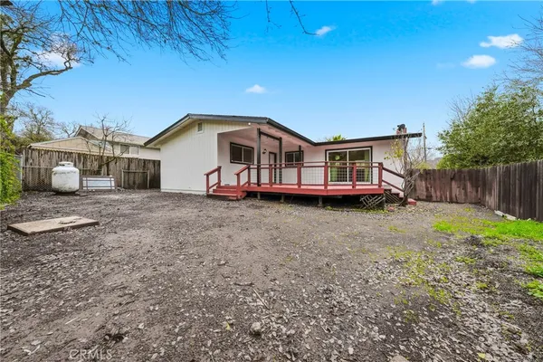 a front view of a house with a garden and deck