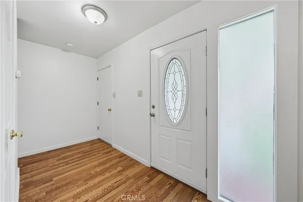 a view of a room with wooden floor