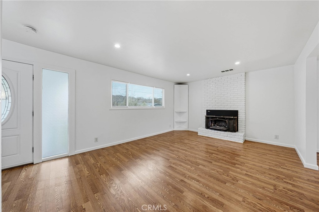 6150 Ridgeview Drive Clearlake, CA 95422 - Photo 8 of 38 a view of an empty room with wooden floor and a window
