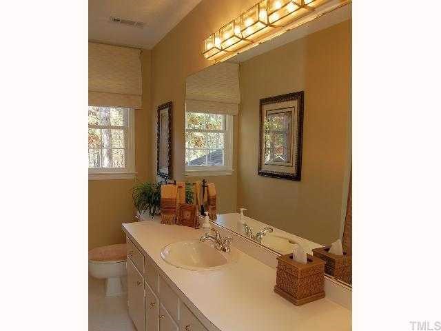 8713 Hidden View Court Raleigh, NC 27613 - Photo 10 of 12 a bathroom with a sink vanity and a mirror