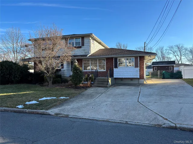 a front view of a house with a yard and a garage