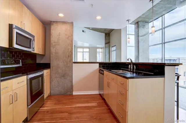 a kitchen with granite countertop a sink and a stove top oven