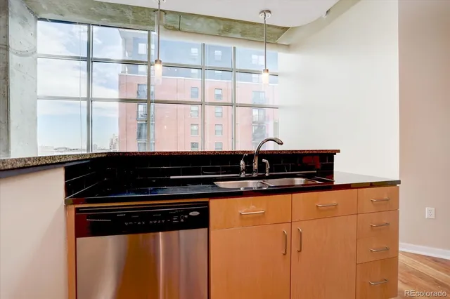 a kitchen with granite countertop a sink and a stove
