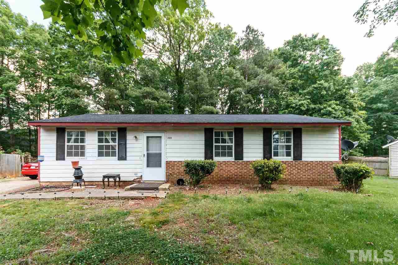 2009 Atkins Drive Raleigh, NC 27610 - Photo 1 of 18 a view of a house with backyard and a garden