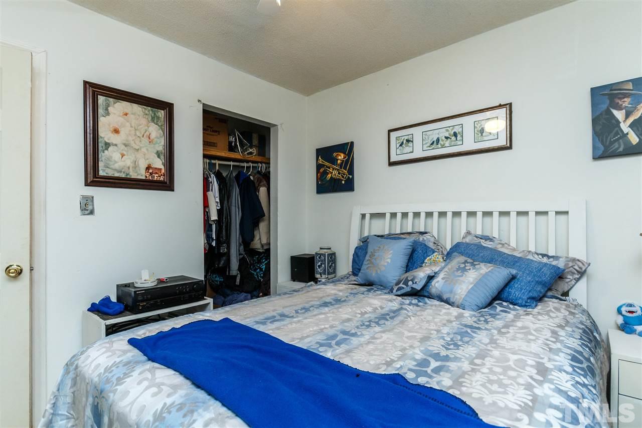 2009 Atkins Drive Raleigh, NC 27610 - Photo 13 of 18 a bed sitting in a bedroom and painting on the wall