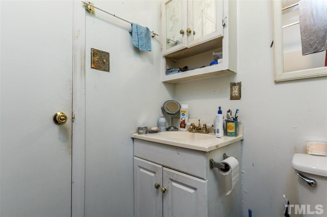 2009 Atkins Drive Raleigh, NC 27610 - Photo 14 of 18 a bathroom with a sink a toilet and shower curtain