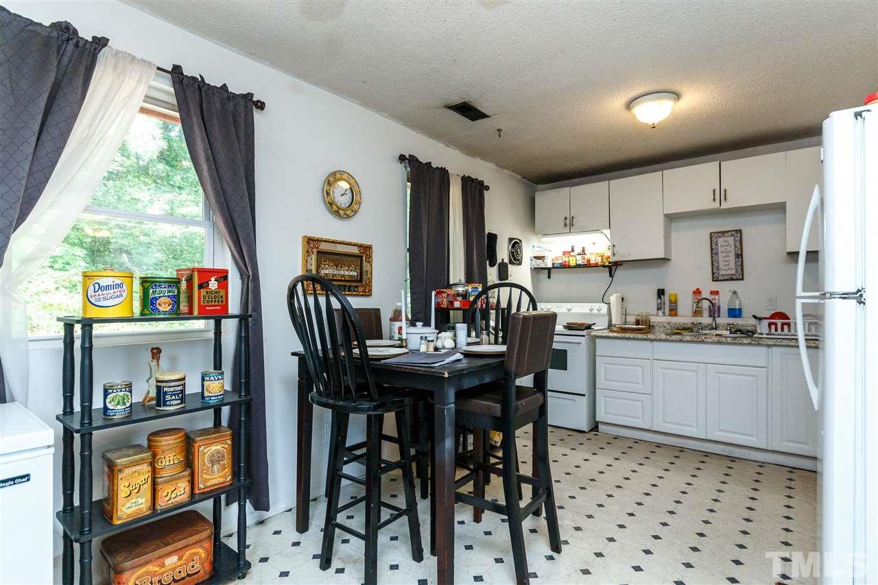 2009 Atkins Drive Raleigh, NC 27610 - Photo 4 of 18 a room with stainless steel appliances granite countertop a dining table chairs refrigerator and sink