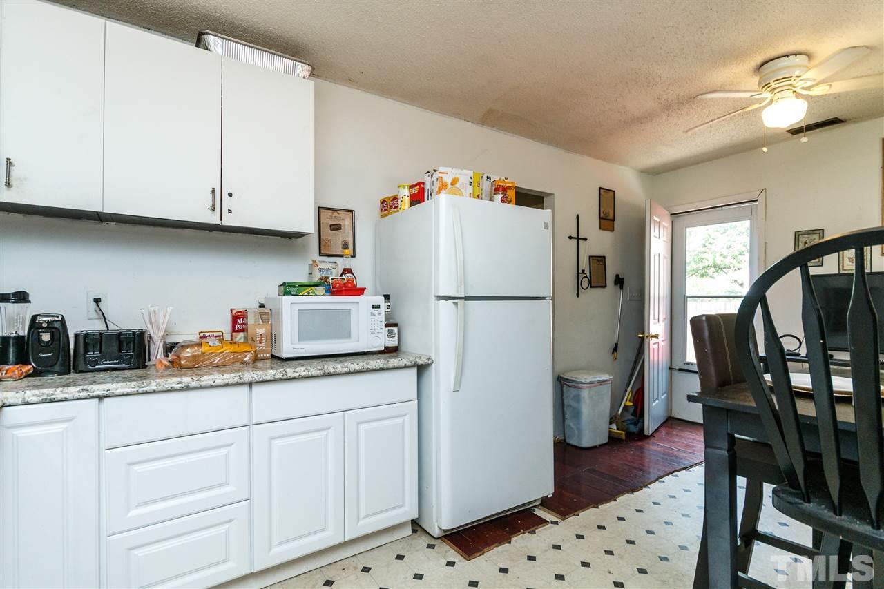 2009 Atkins Drive Raleigh, NC 27610 - Photo 7 of 18 a kitchen with appliances cabinets and wooden floor
