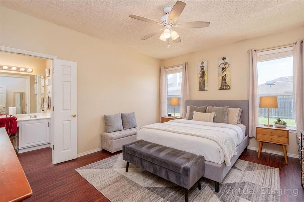 192 Hirth Drive Crowley, TX 76036 - Photo 13 of 22 a bedroom with a large bed and a chandelier