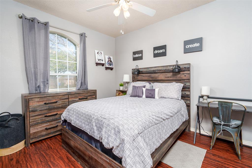 192 Hirth Drive Crowley, TX 76036 - Photo 17 of 22 a bedroom with a bed and a chandelier