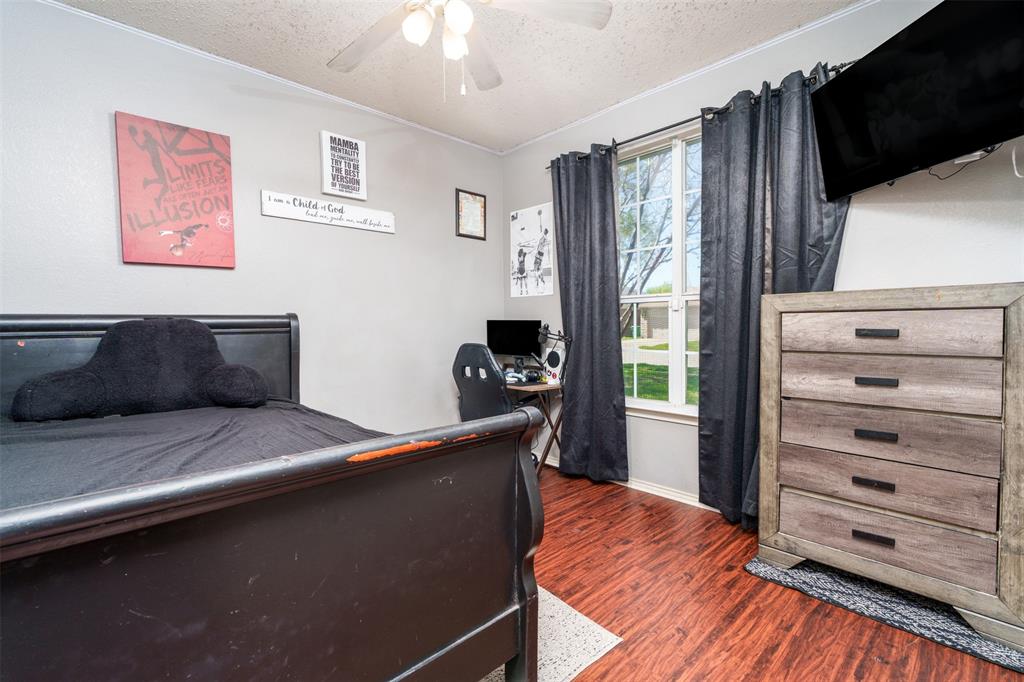 192 Hirth Drive Crowley, TX 76036 - Photo 19 of 22 a bedroom with a bed and wooden floor