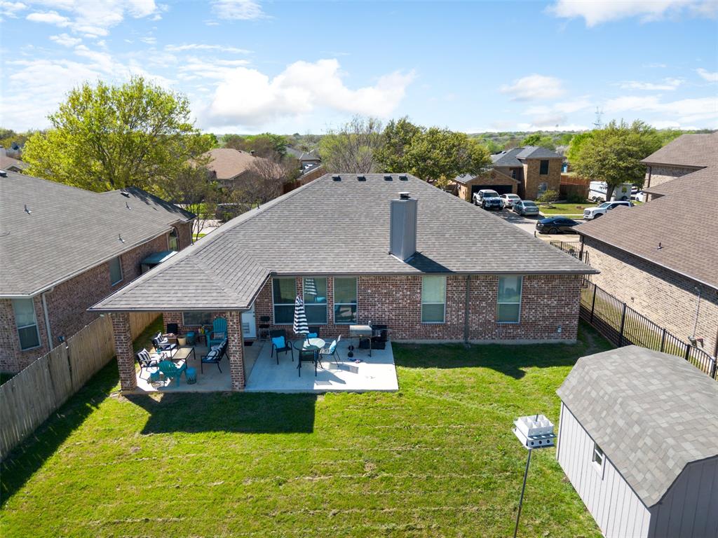 192 Hirth Drive Crowley, TX 76036 - Photo 20 of 22 a view of a house with a big yard potted plants and large tree