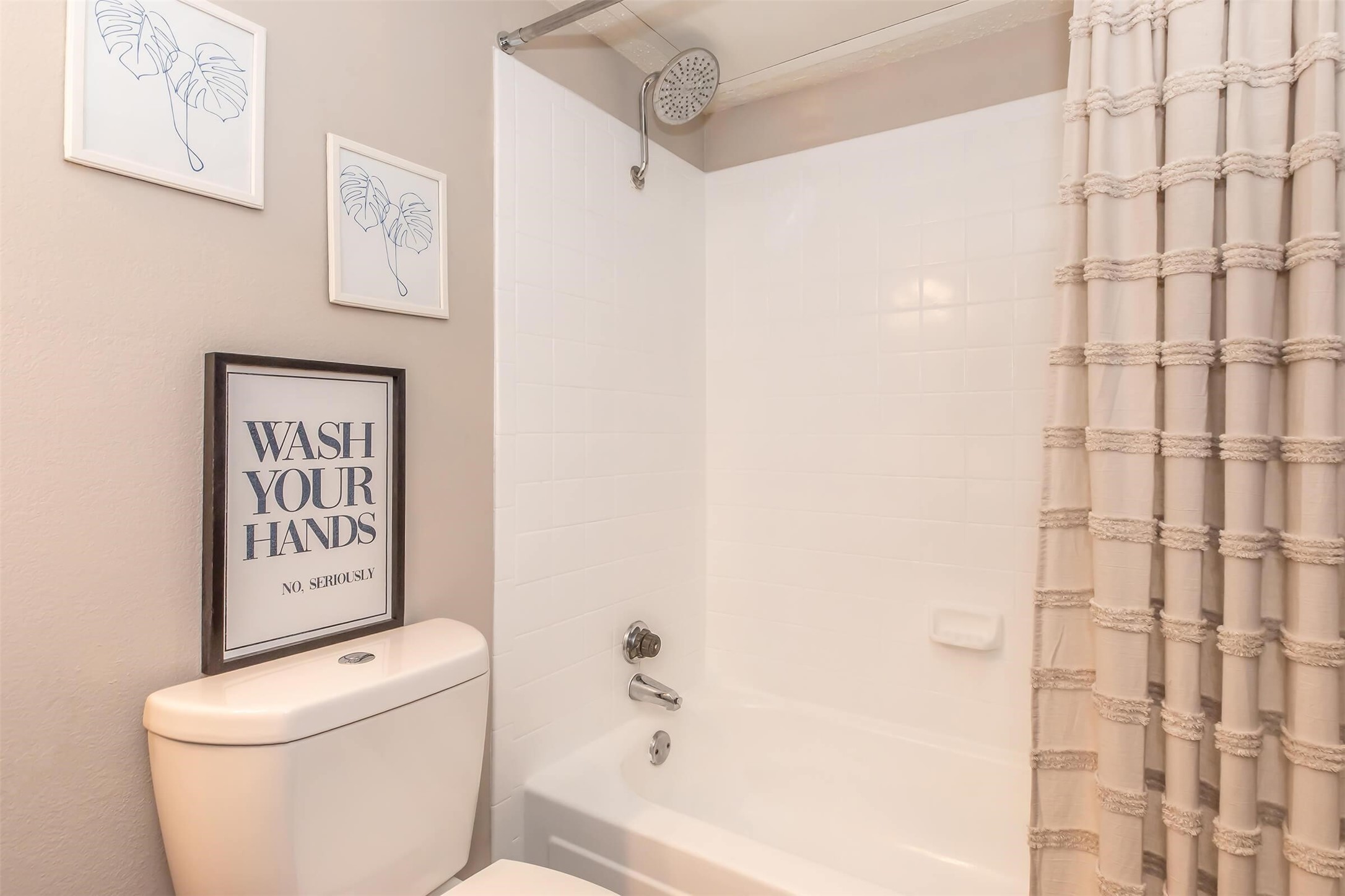 8301 Boat Club Road, Unit 827 Fort Worth, TX 76179 - Photo 7 of 42 a white toilet sitting next to a shower curtain