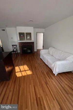 a spacious bedroom with a bed and wooden floor
