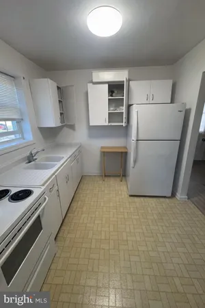 a kitchen with a sink a stove and refrigerator