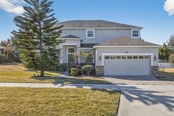 a front view of a house with swimming pool and porch