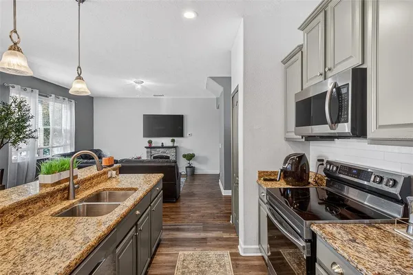a kitchen with microwave and cabinets