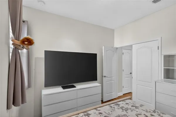 a bedroom with a bed and a chandelier