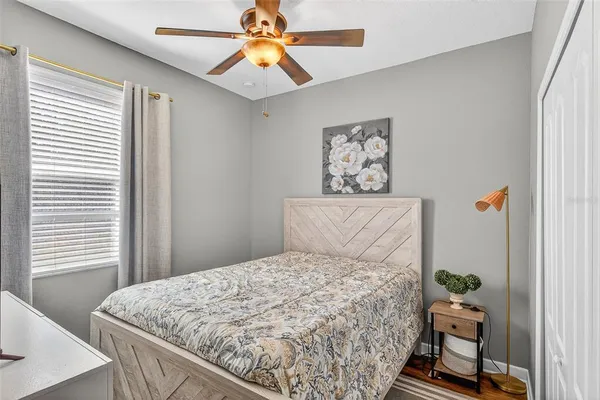 a bedroom with a bed and wooden floor