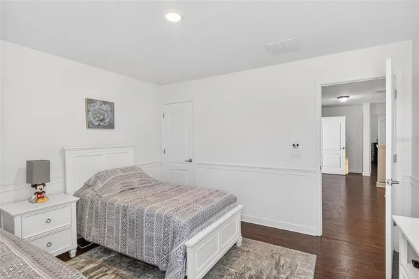 a bathroom with a granite countertop tub sink and mirror