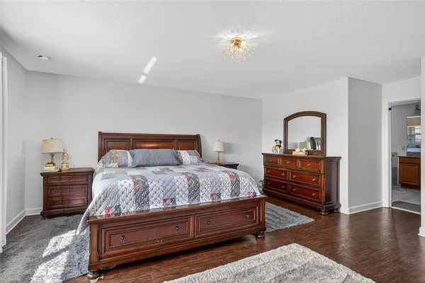 a work room with furniture a rug and a window
