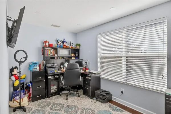 a view of a patio with table and chairs potted plants and a large tree