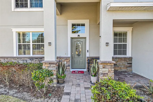 a view of a dining room with furniture a chandelier and wooden floor