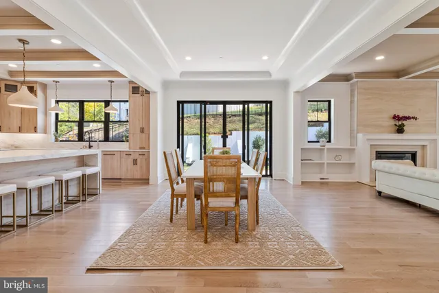 a large white kitchen with a table and chairs