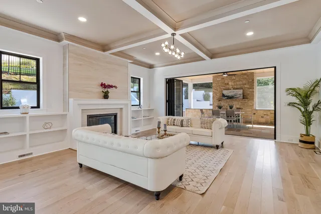 a living room with furniture large window and a fireplace