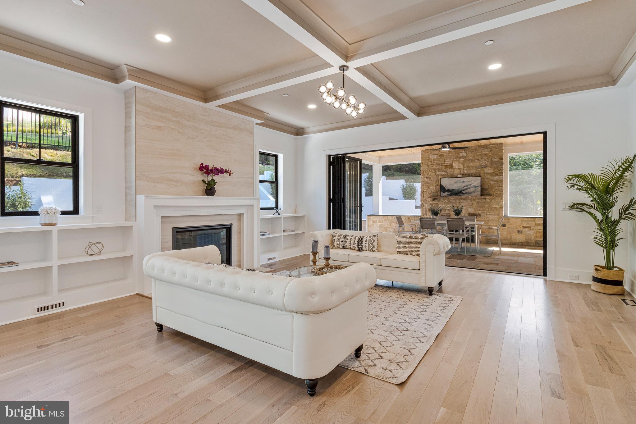 7709 Sebago Road Bethesda, MD 20817 - Photo 17 of 65 a living room with furniture large window and a fireplace