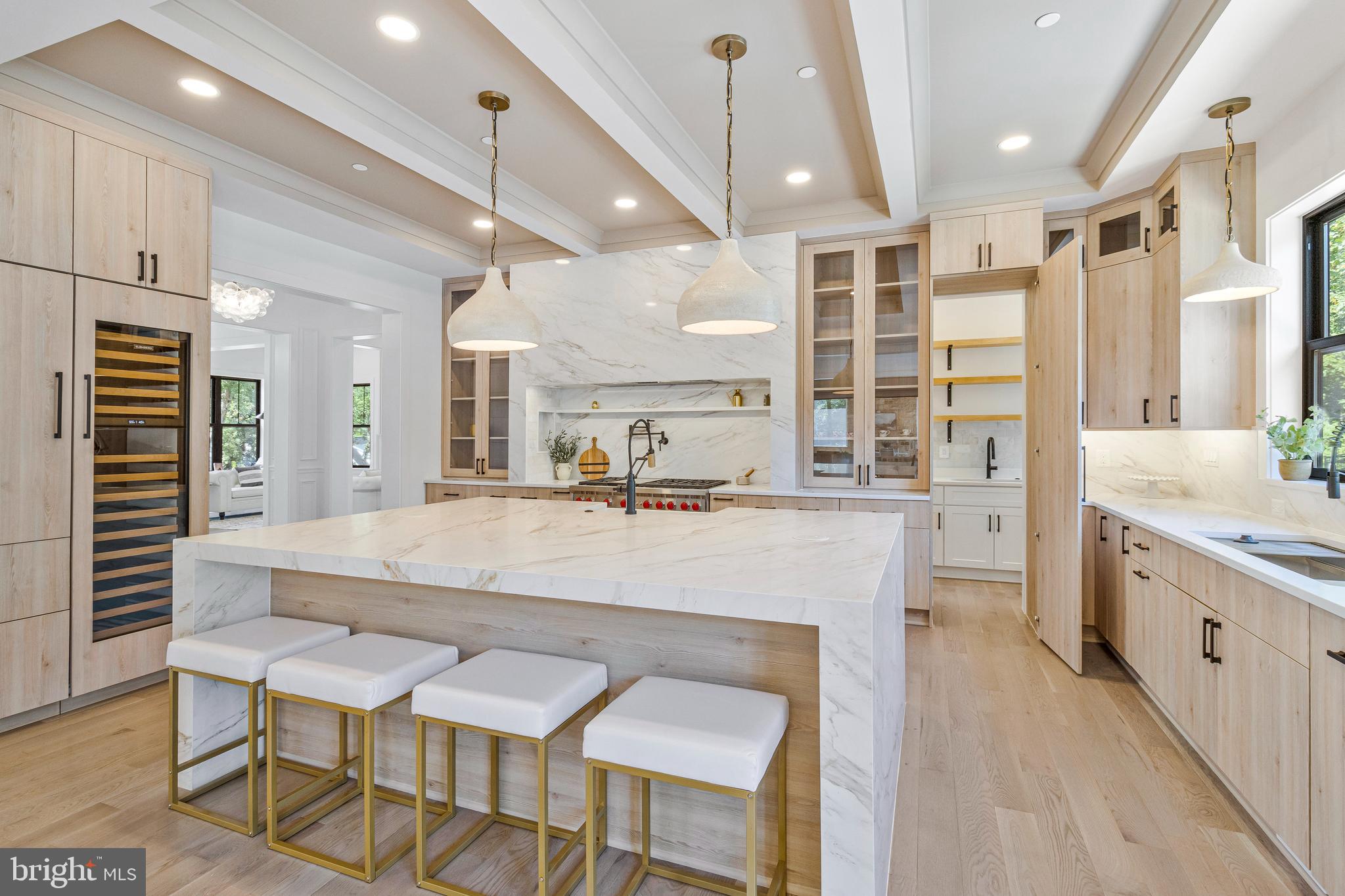 7709 Sebago Road Bethesda, MD 20817 - Photo 18 of 65 a large white kitchen with a table and chairs