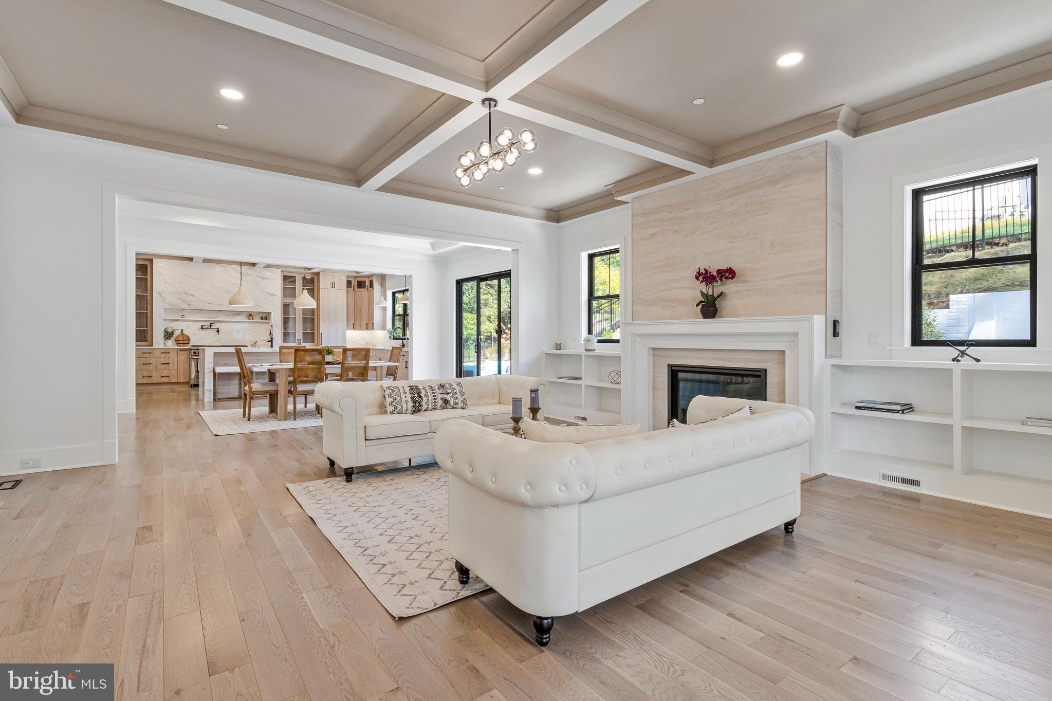 7709 Sebago Road Bethesda, MD 20817 - Photo 20 of 65 a living room with furniture large window and a fireplace