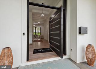 7709 Sebago Road Bethesda, MD 20817 - Photo 2 of 65 a view of a hallway with wooden floor and entryway