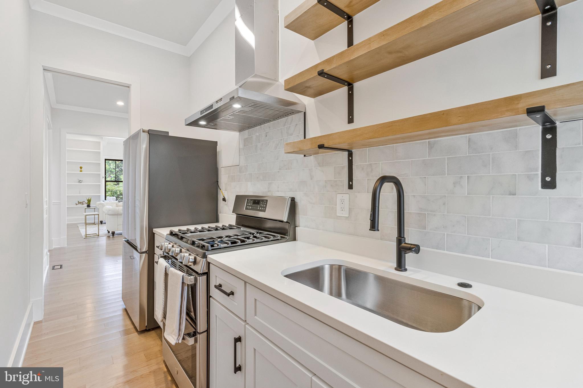 7709 Sebago Road Bethesda, MD 20817 - Photo 22 of 65 a kitchen with stainless steel appliances granite countertop a sink and a refrigerator