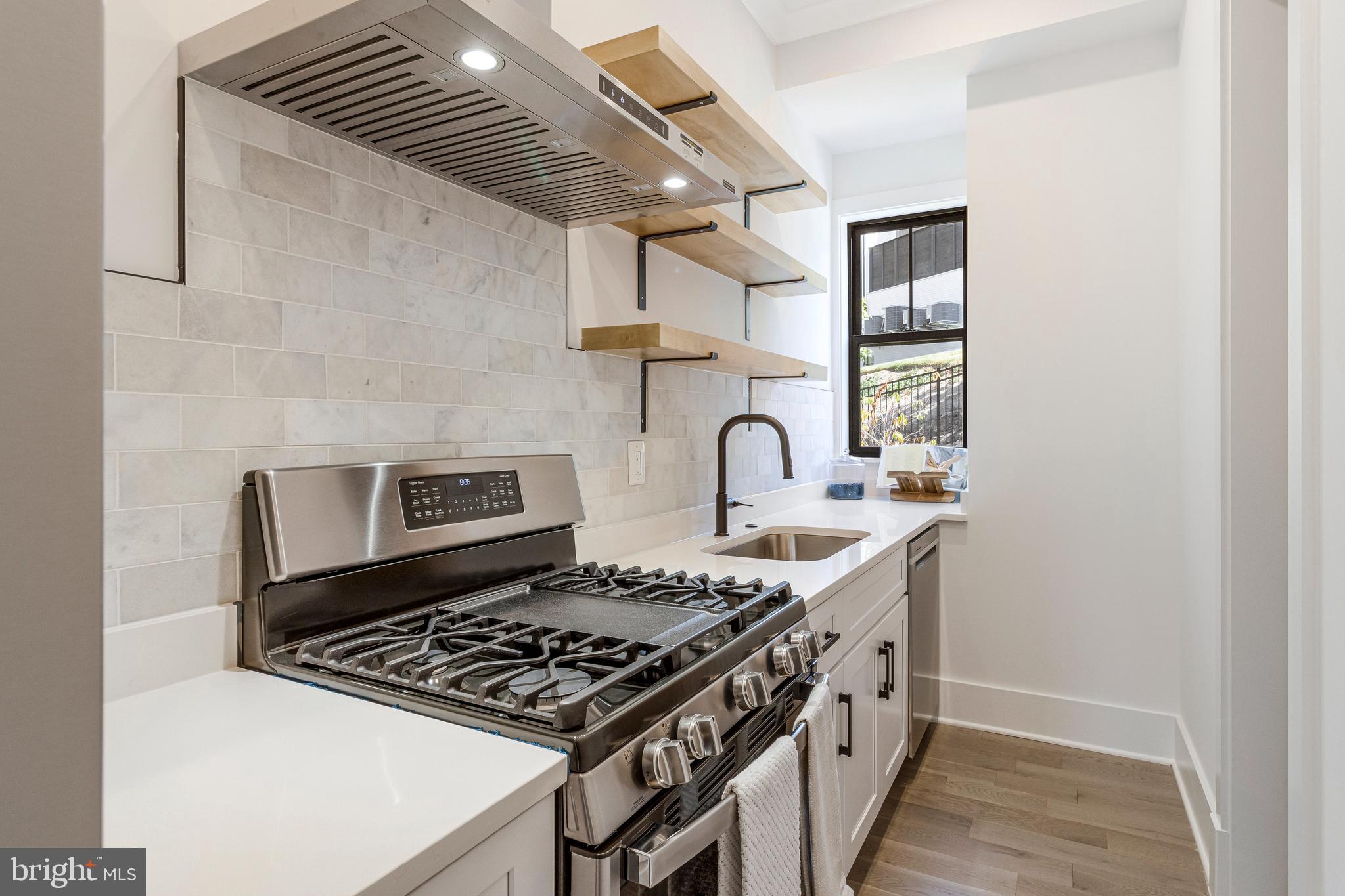 7709 Sebago Road Bethesda, MD 20817 - Photo 24 of 68 a kitchen with stainless steel appliances granite countertop a stove and a sink