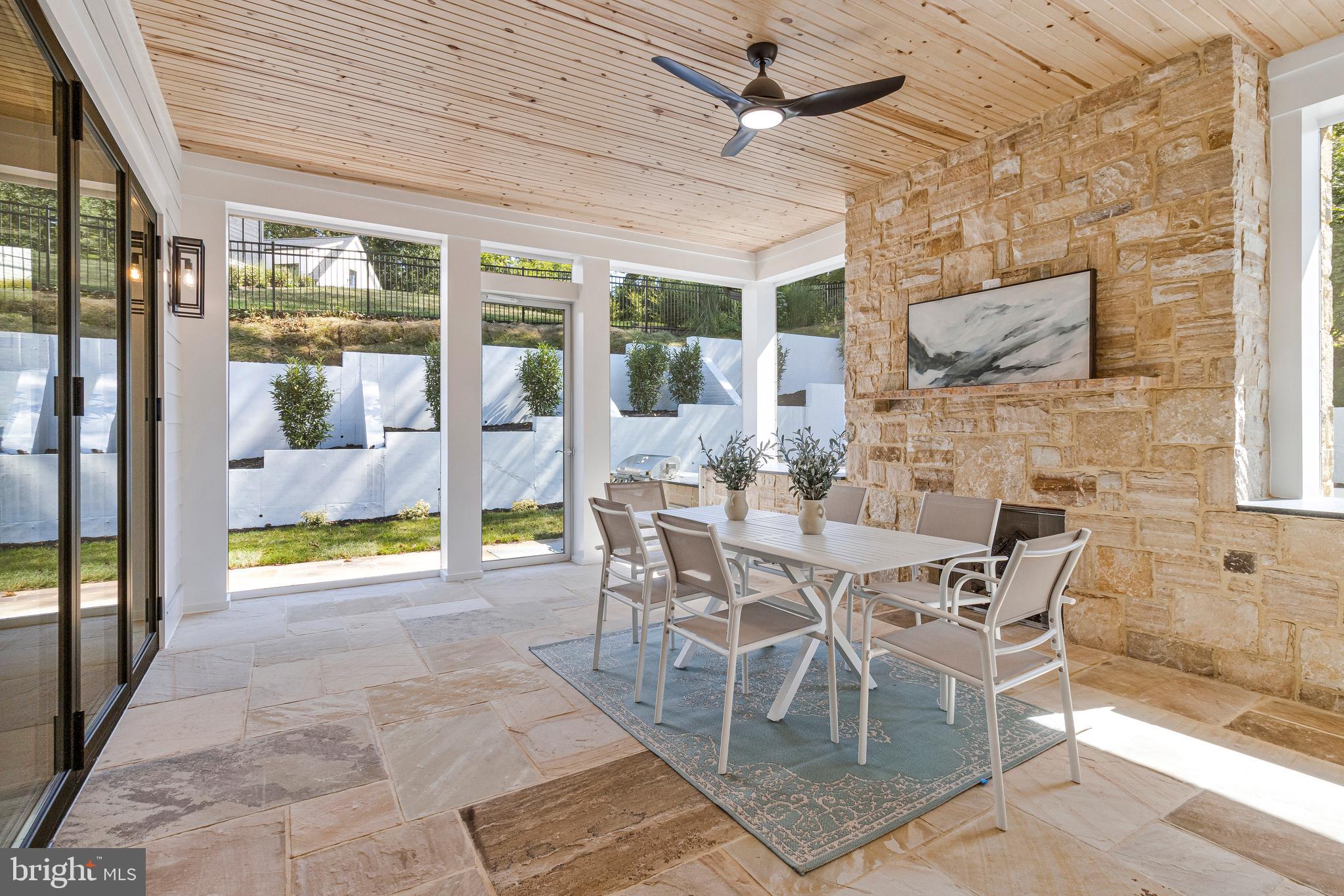 7709 Sebago Road Bethesda, MD 20817 - Photo 28 of 65 a view of a dining room with furniture large windows and wooden floor