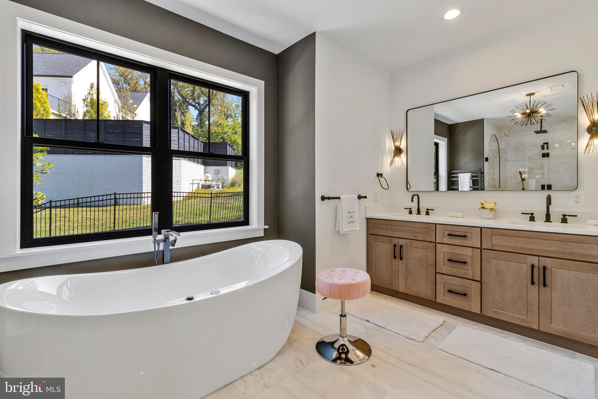 7709 Sebago Road Bethesda, MD 20817 - Photo 28 of 40 a spacious bathroom with a tub double sink window and mirror