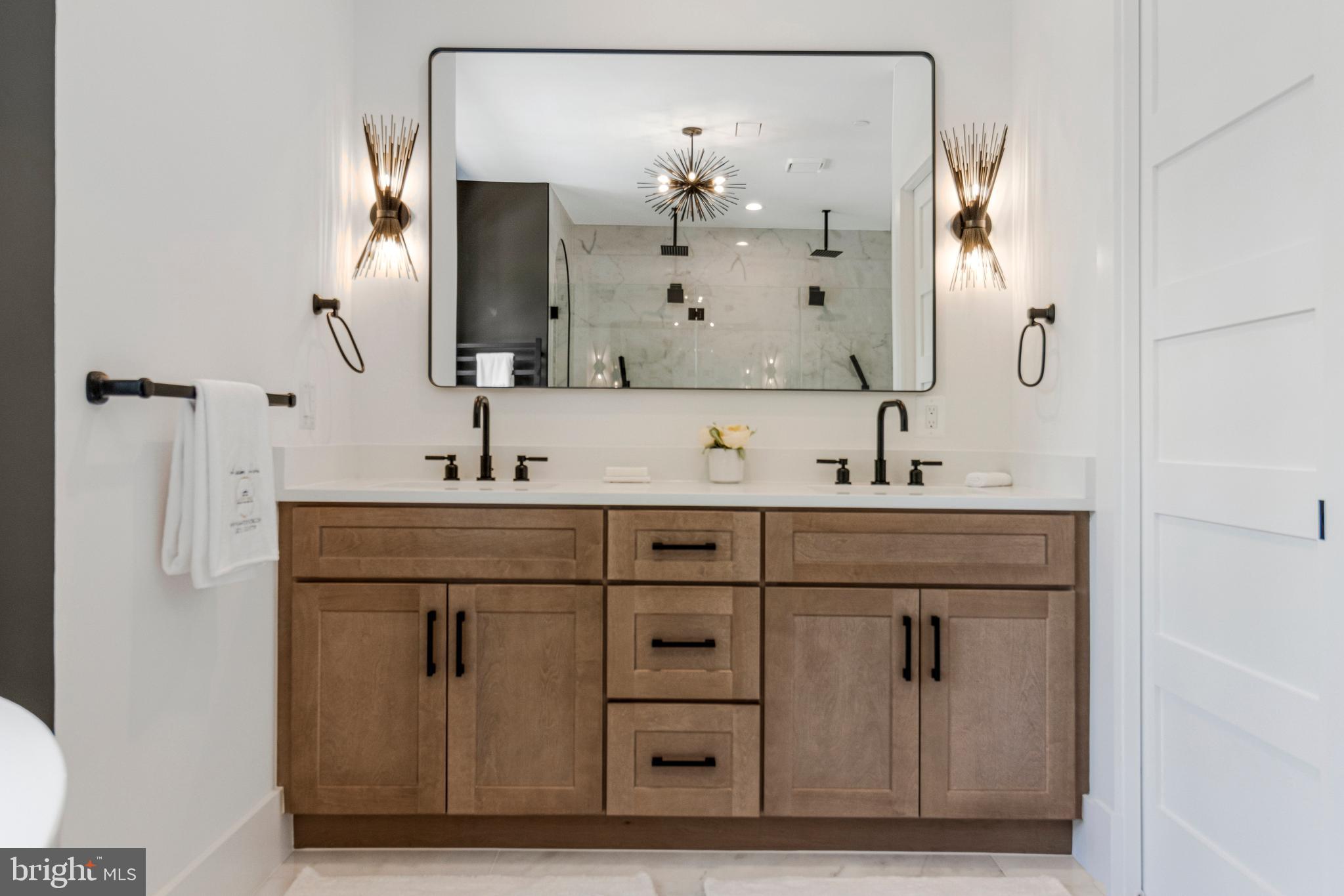 7709 Sebago Road Bethesda, MD 20817 - Photo 30 of 40 a bathroom with a sink vanity and a mirror