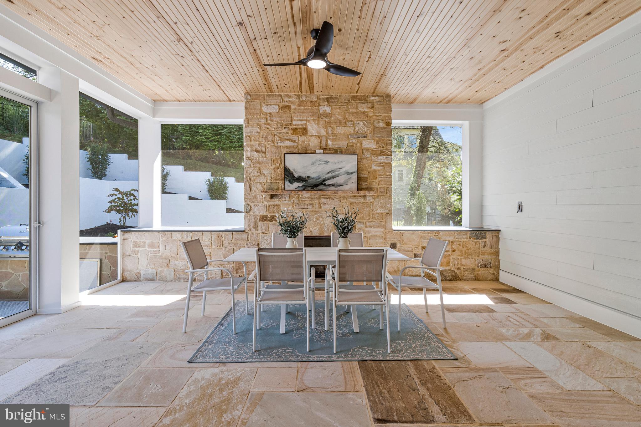 7709 Sebago Road Bethesda, MD 20817 - Photo 30 of 68 a dining room with wooden floor a chandelier a glass table and chairs